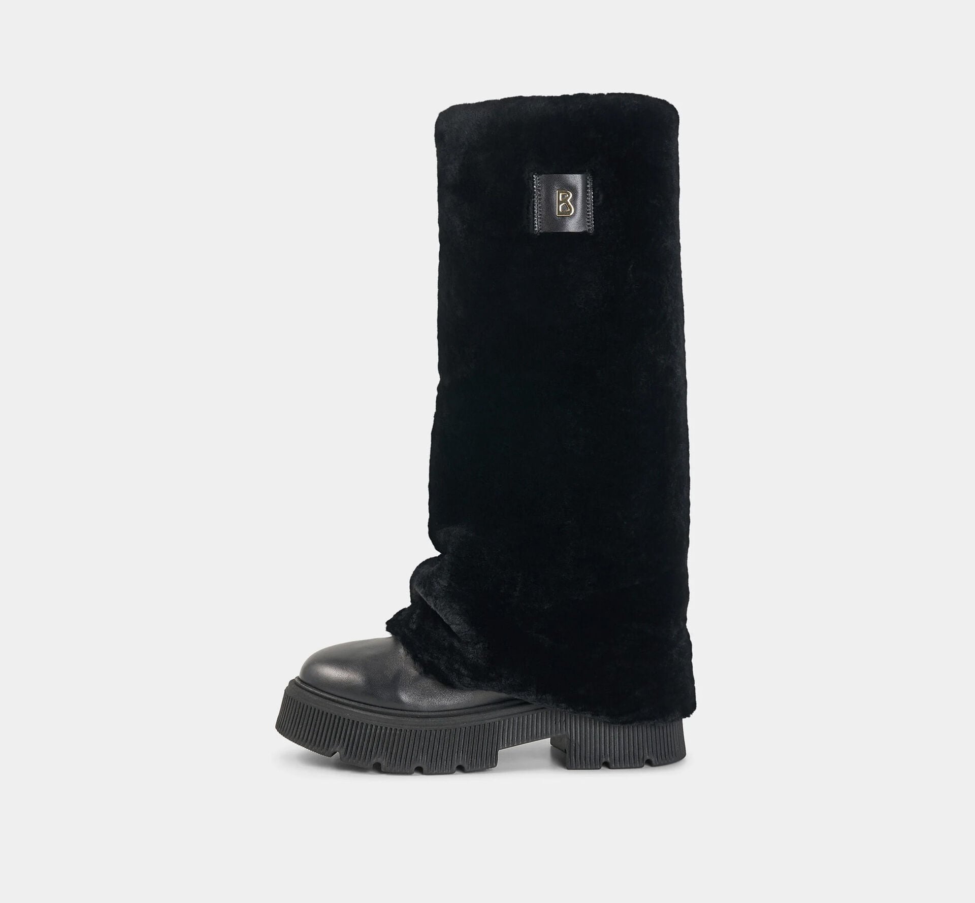 This photo shows the Turin leather boots with a soft lambskin overlay, platform soles and a logo detail on the side.