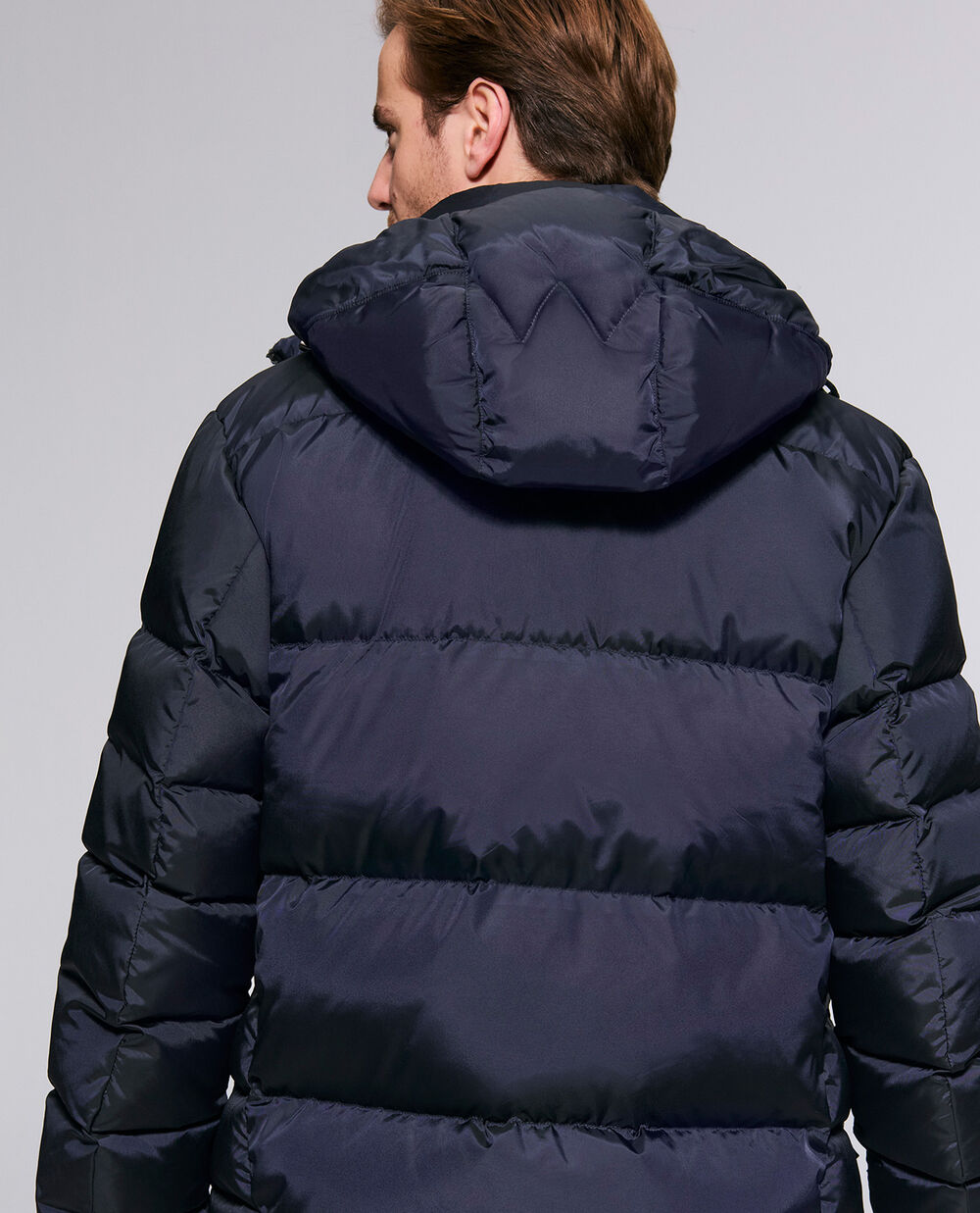 This photo shows the Jamy down jacket with an exclusive &lsquo;W&rsquo; detail on the back of the hood.