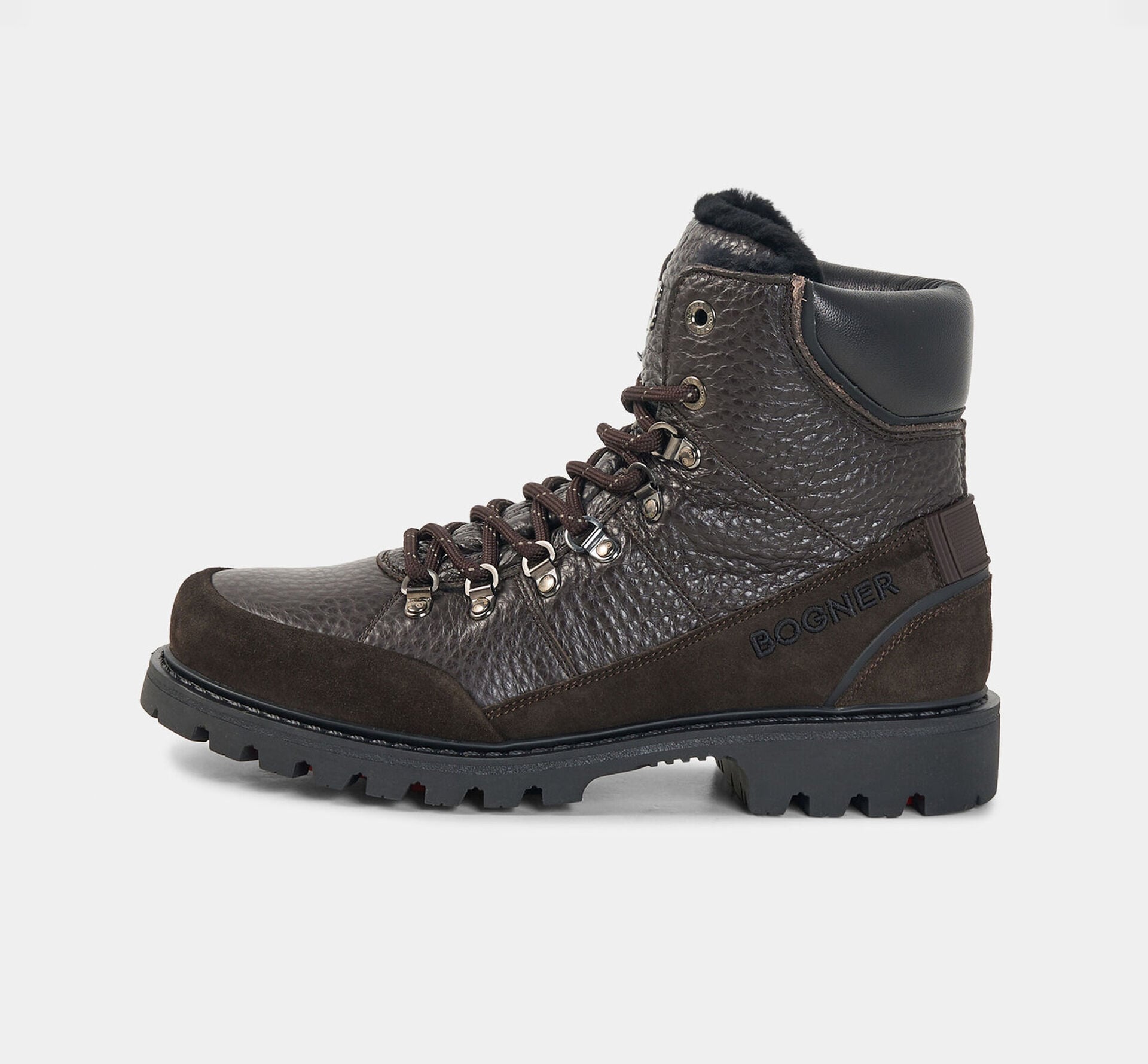 This photo shows the dark brown Helsinki lace-up boots with lambskin fur lining and &lsquo;B&rsquo; logo details.