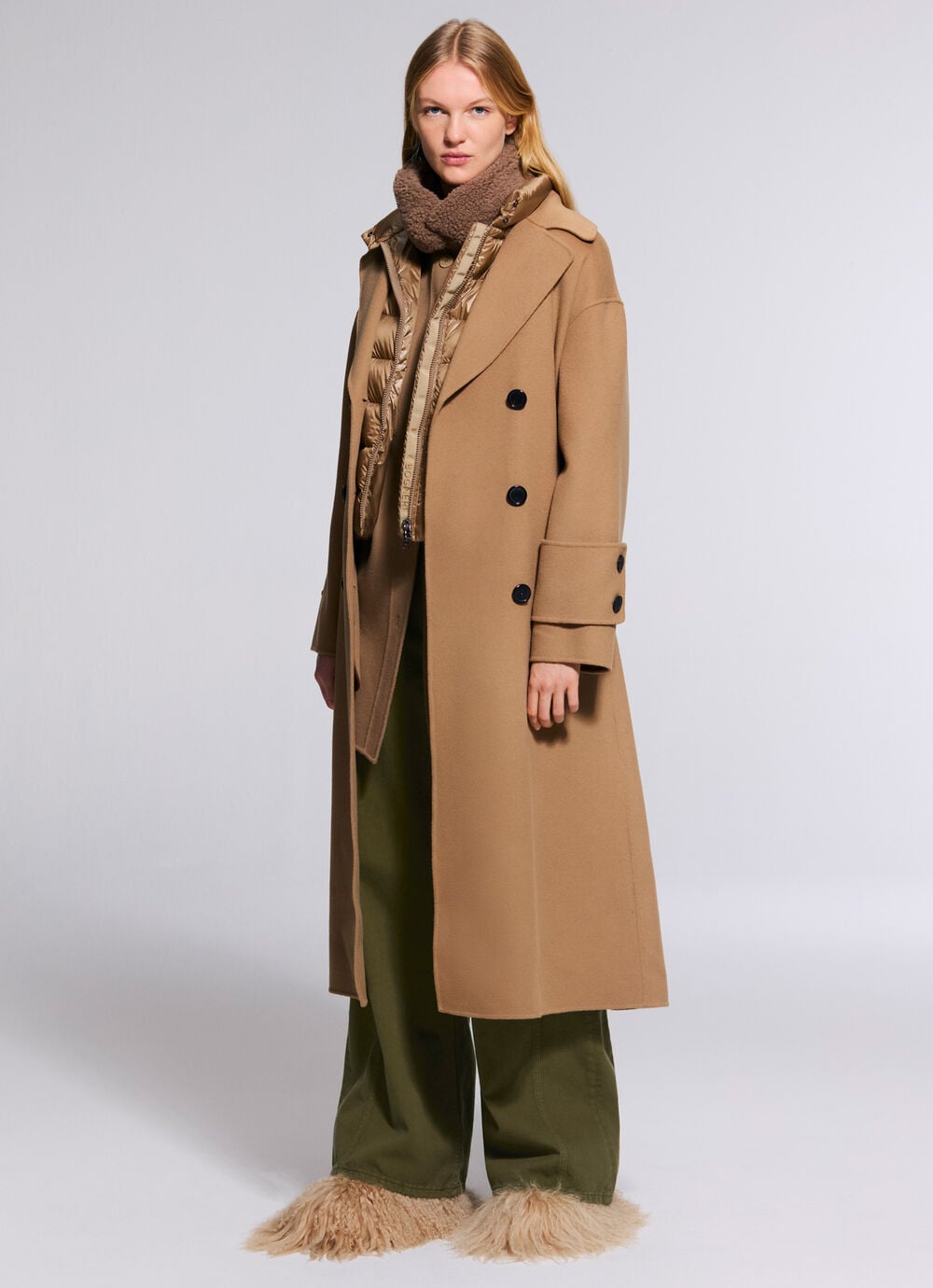 The third female model is wearing the Terese double-faced coat in camel over the Milly lightweight down jacket, Lizzy jeans and fur boots.