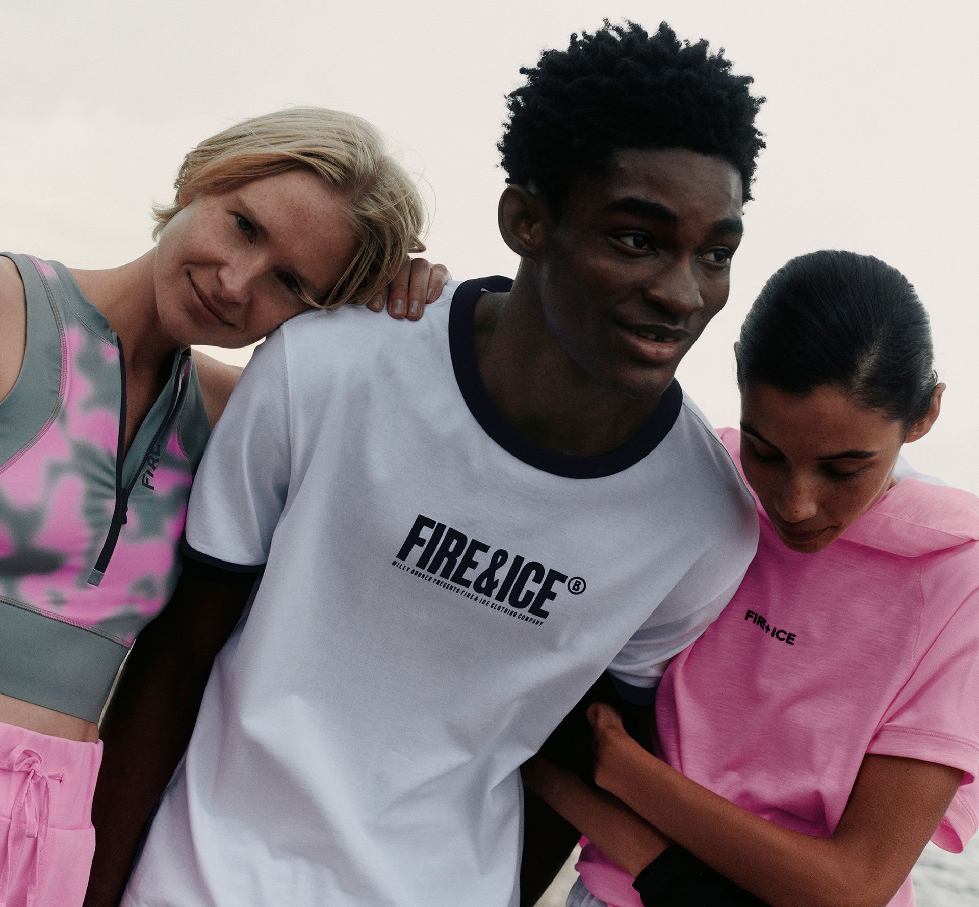 Three models standing side by side in FIRE+ICE Active Wear styles featuring distinctive logo details.