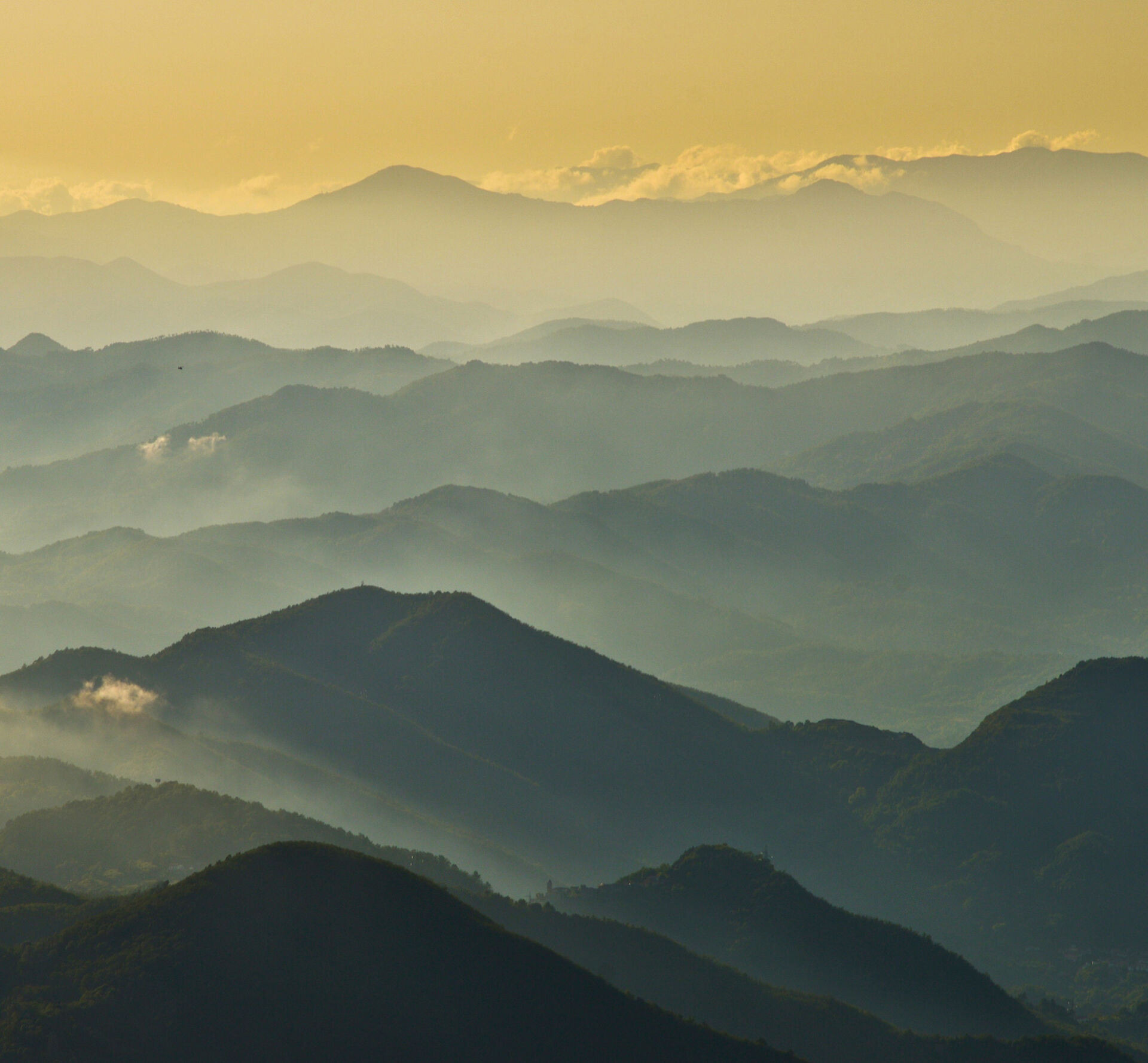 Photograph of a cloud-covered mountain landscape.