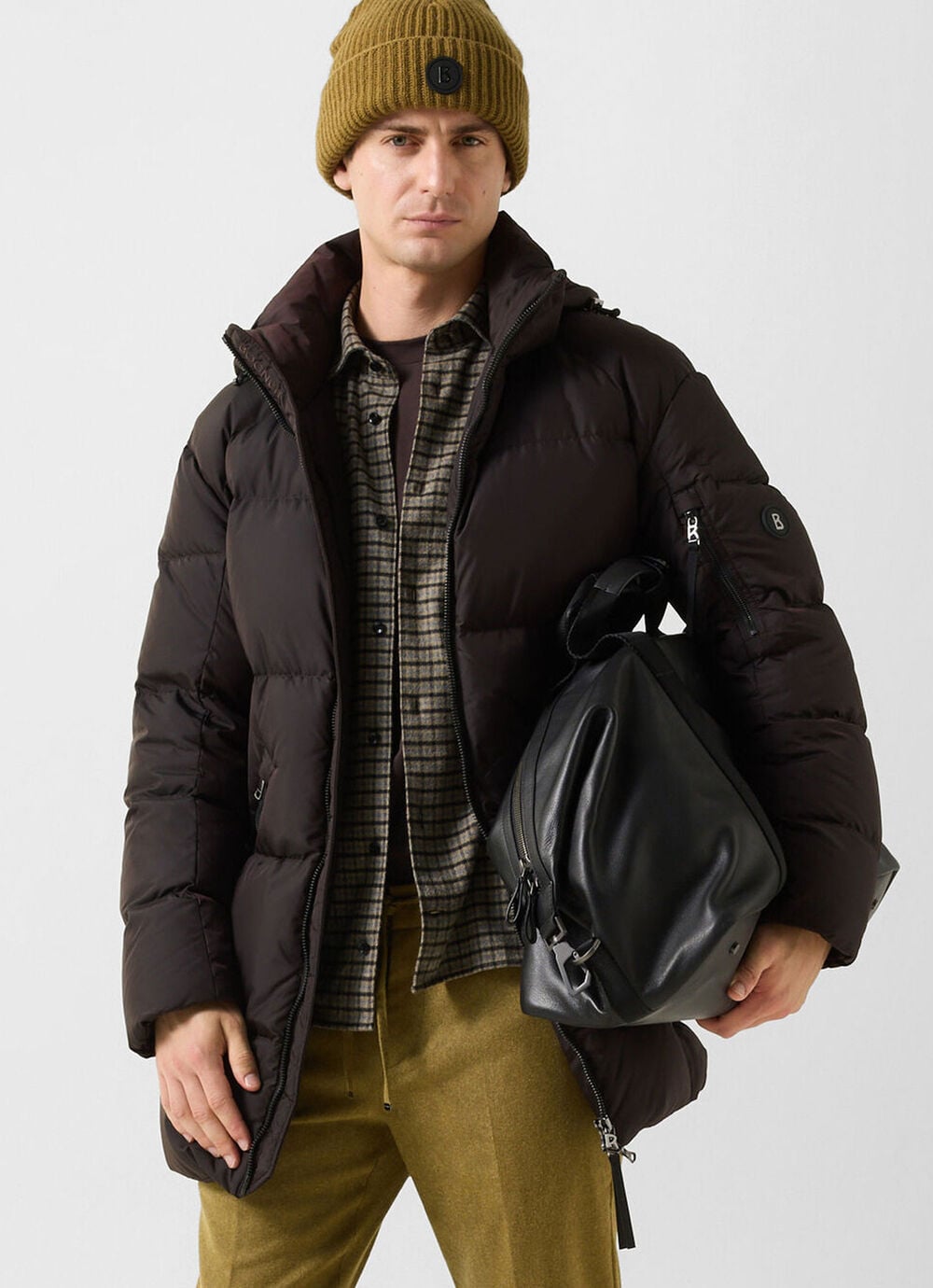 The other male model is wearing the Jones BOGNER jacket in olive green, over the Hard check shirt and Riley wool-blend business pants.