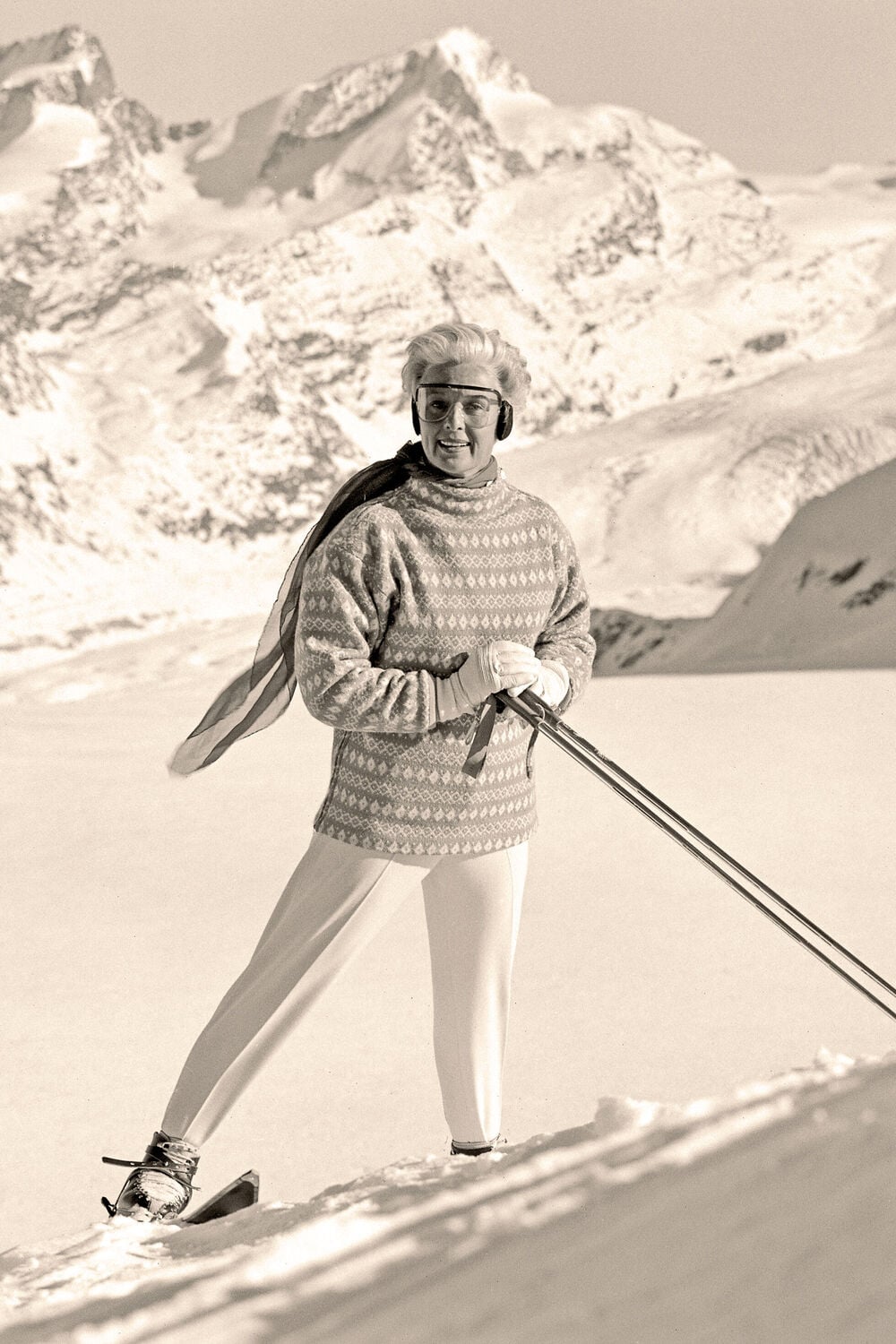This black-and-white photography shows Maria Bogner in her iconic trousers against a backdrop of snow-capped peaks.