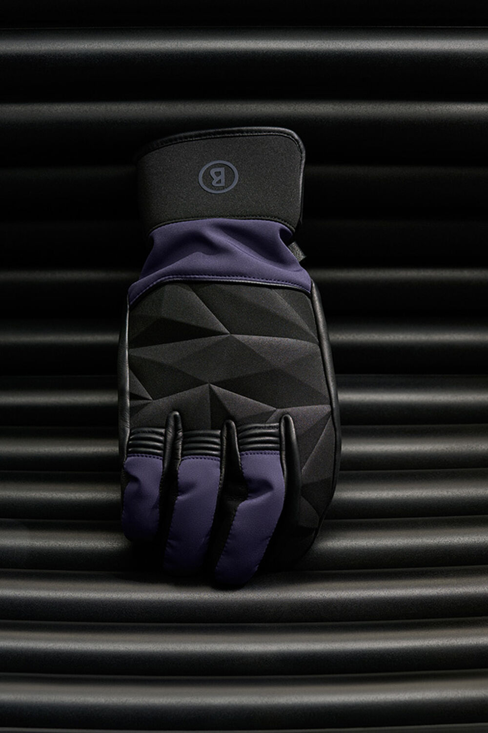 These purple and black ski gloves with the B logo have an elegant diamond pattern.