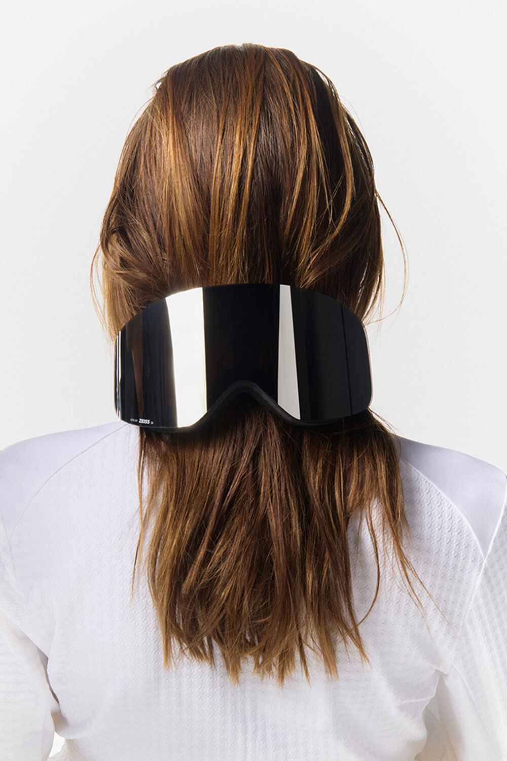 A creative use of the black ski goggles, placed at the back of the long-haired model's head.