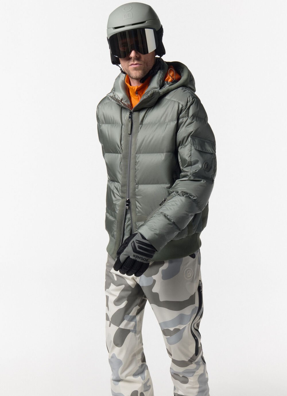 This look comprises the Samir olive green down ski jacket, camouflage trousers and first layer in orange.