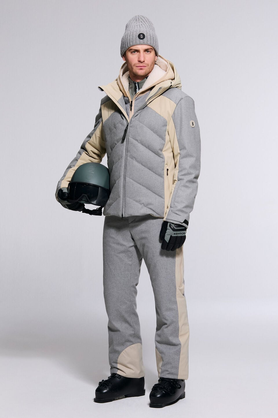The model is wearing the Flann outdoor jacket with the Firat ski trousers, paired with the St Moritz ski helmet.