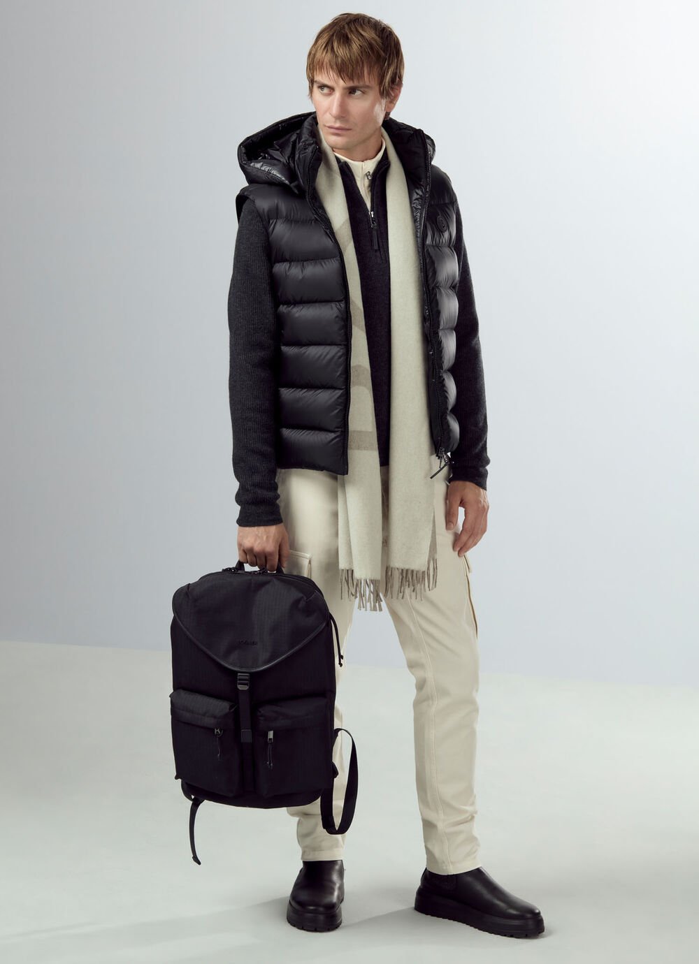 The male model's look is shown in full – with black down, scarf and light-coloured cargo trousers.