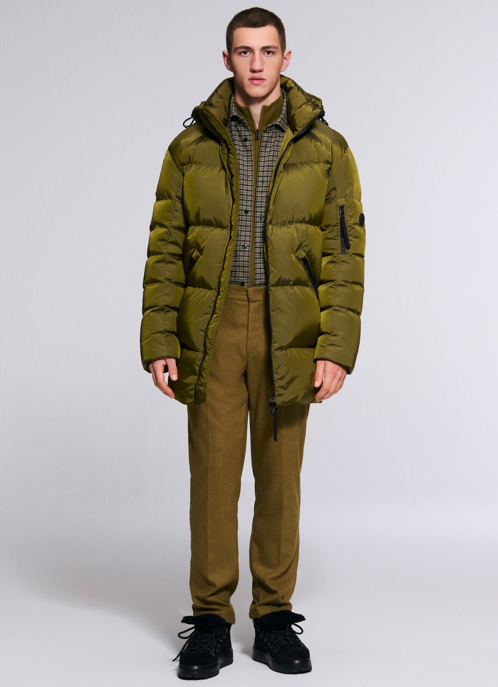 The other male model is wearing the Jones BOGNER jacket in olive green, over the Hard check shirt and Riley wool-blend business trousers.