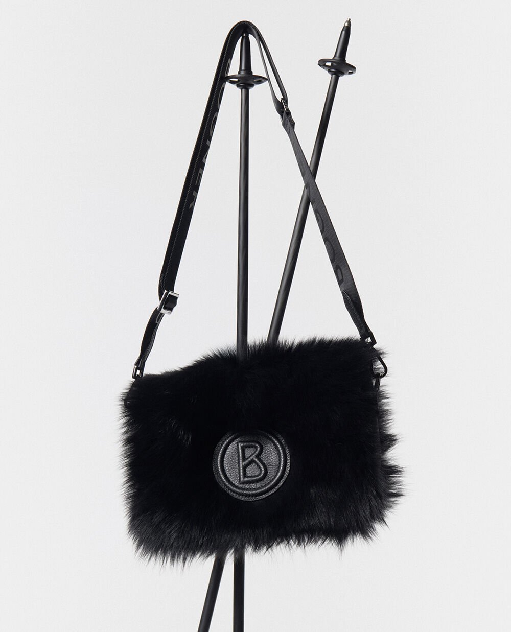 On this image you can see a black shoulder bag with the B logo and fur trim.
