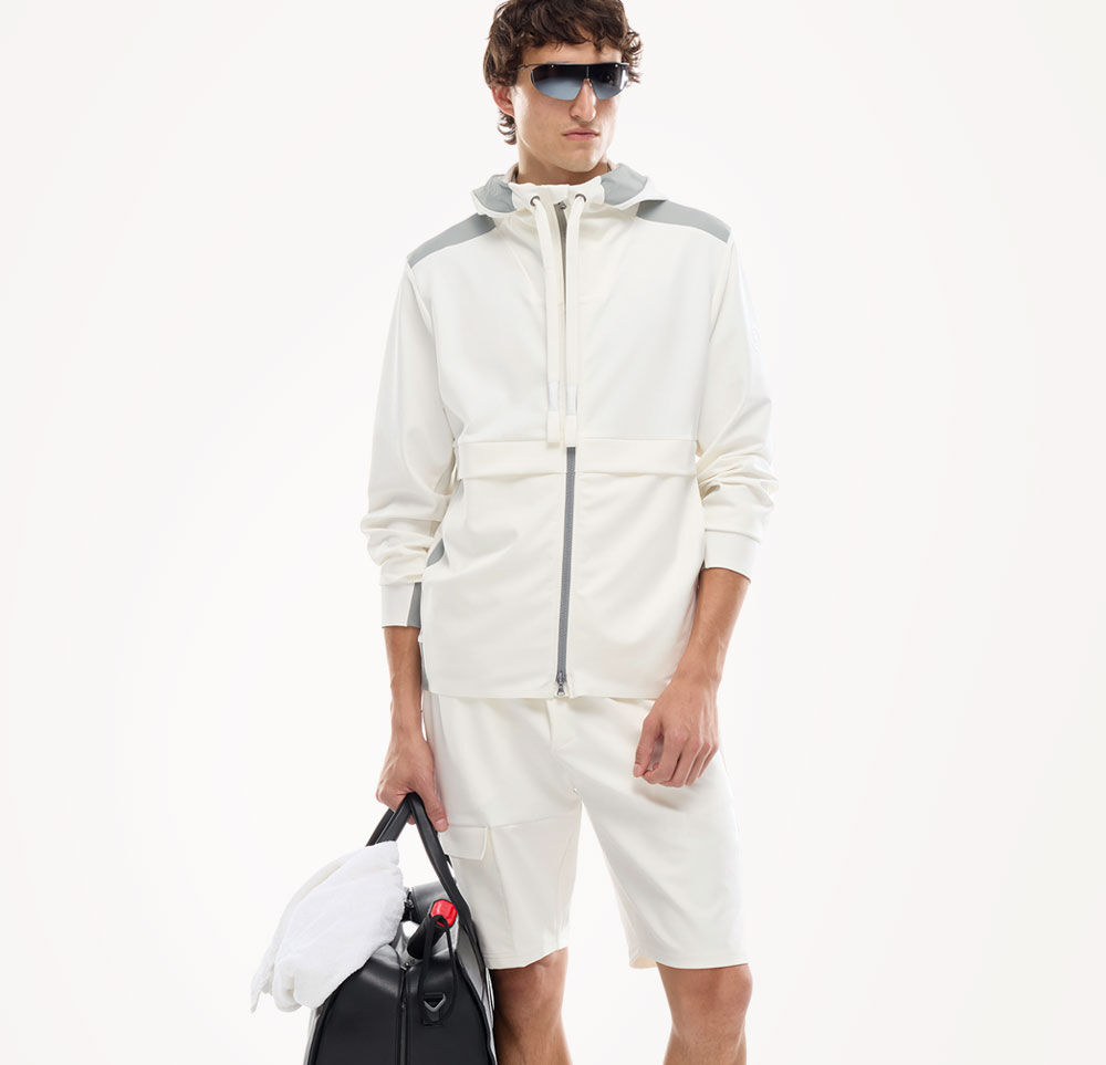 The Ernesto sweatshirt jacket in white and grey is paired here with matching shorts on the male model.