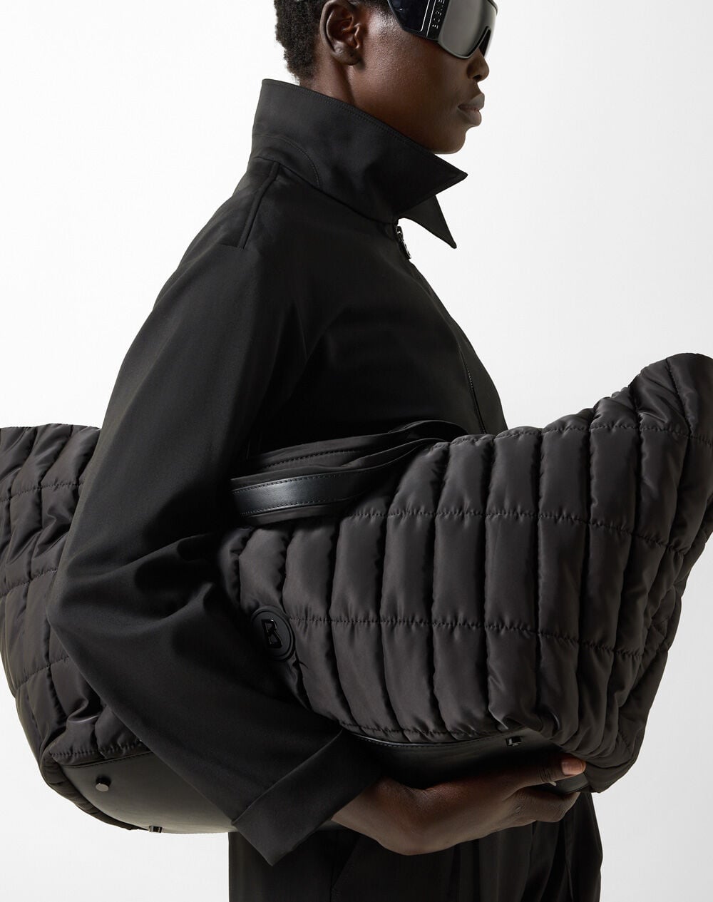 Black Thyon Zaha shopper with tubular quilting, short and long handles, and signature B detail.