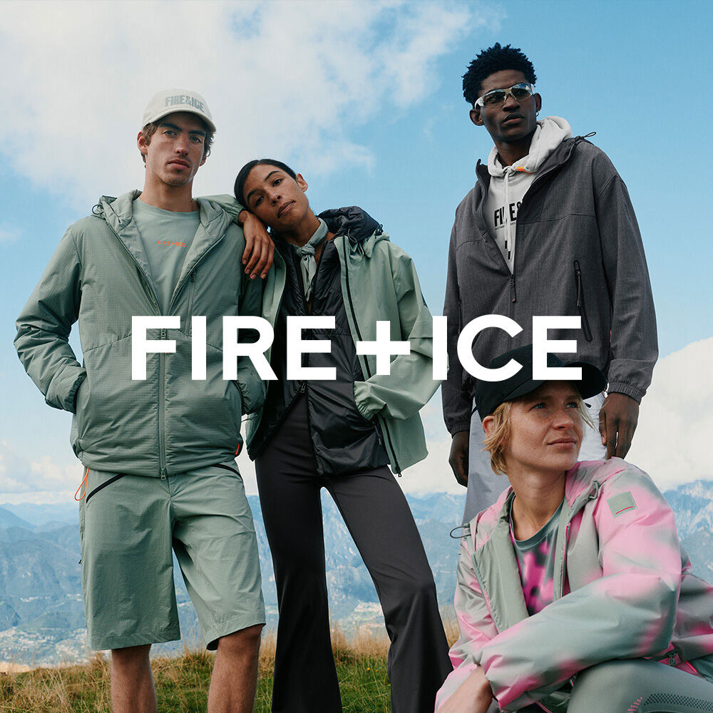 A group of four models wearing FIRE+ICE functional sportswear. They stand in front of a mountain landscape.