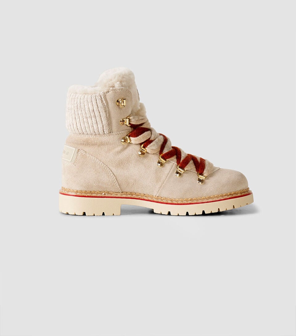 The Andermatt lace-up boots in beige are crafted from suede and feature contrasting red and beige laces, a shearling lining and logo details.