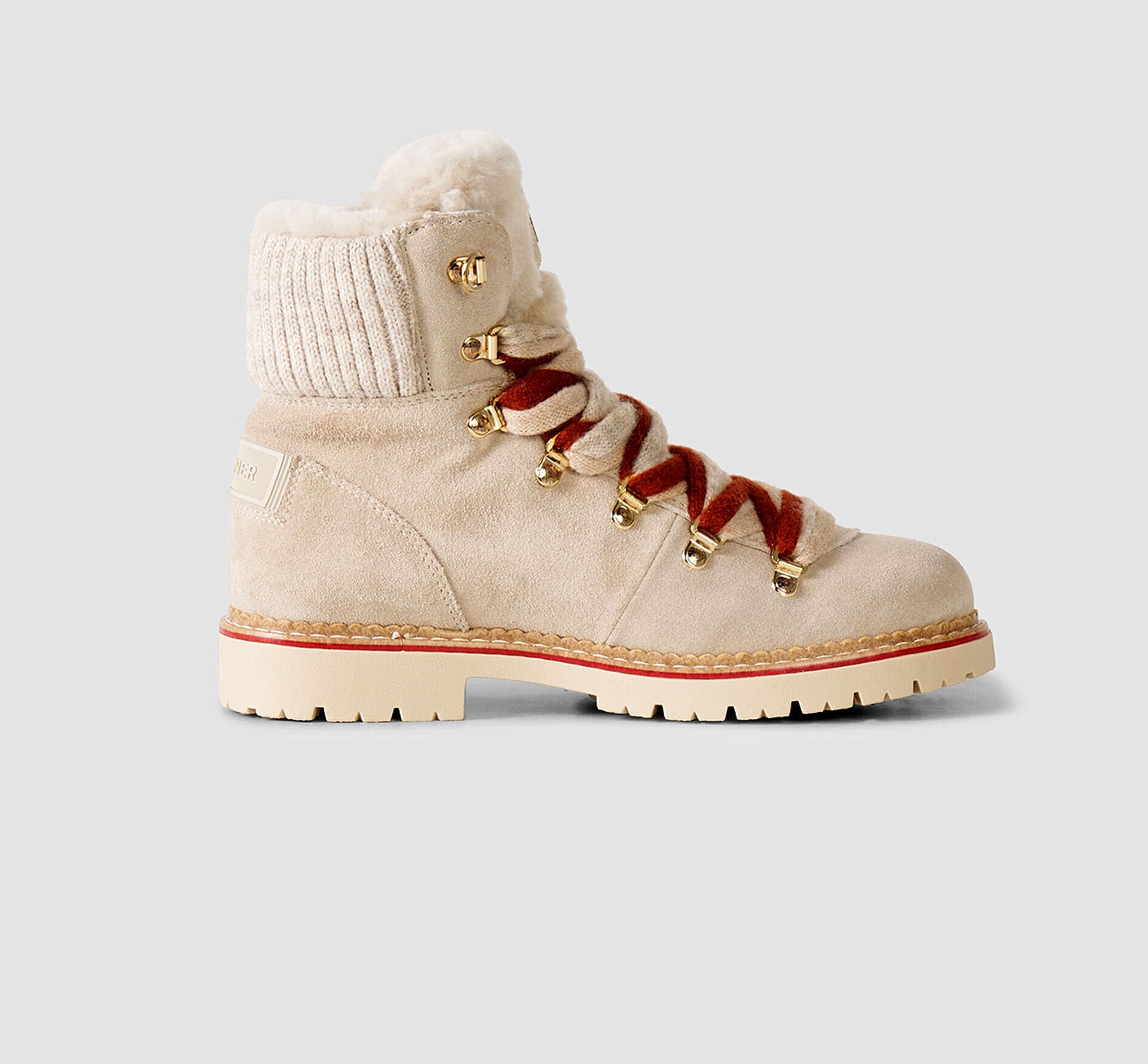 The Andermatt lace-up boots in beige are crafted from suede and feature contrasting red and beige laces, a shearling lining and logo details.