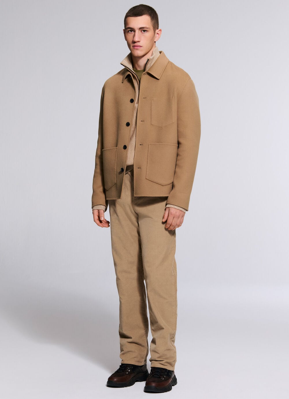 The third male model is wearing a total look in beige, comprising the Mirco shirt jacket, Dwayne pullover and Travis trousers.