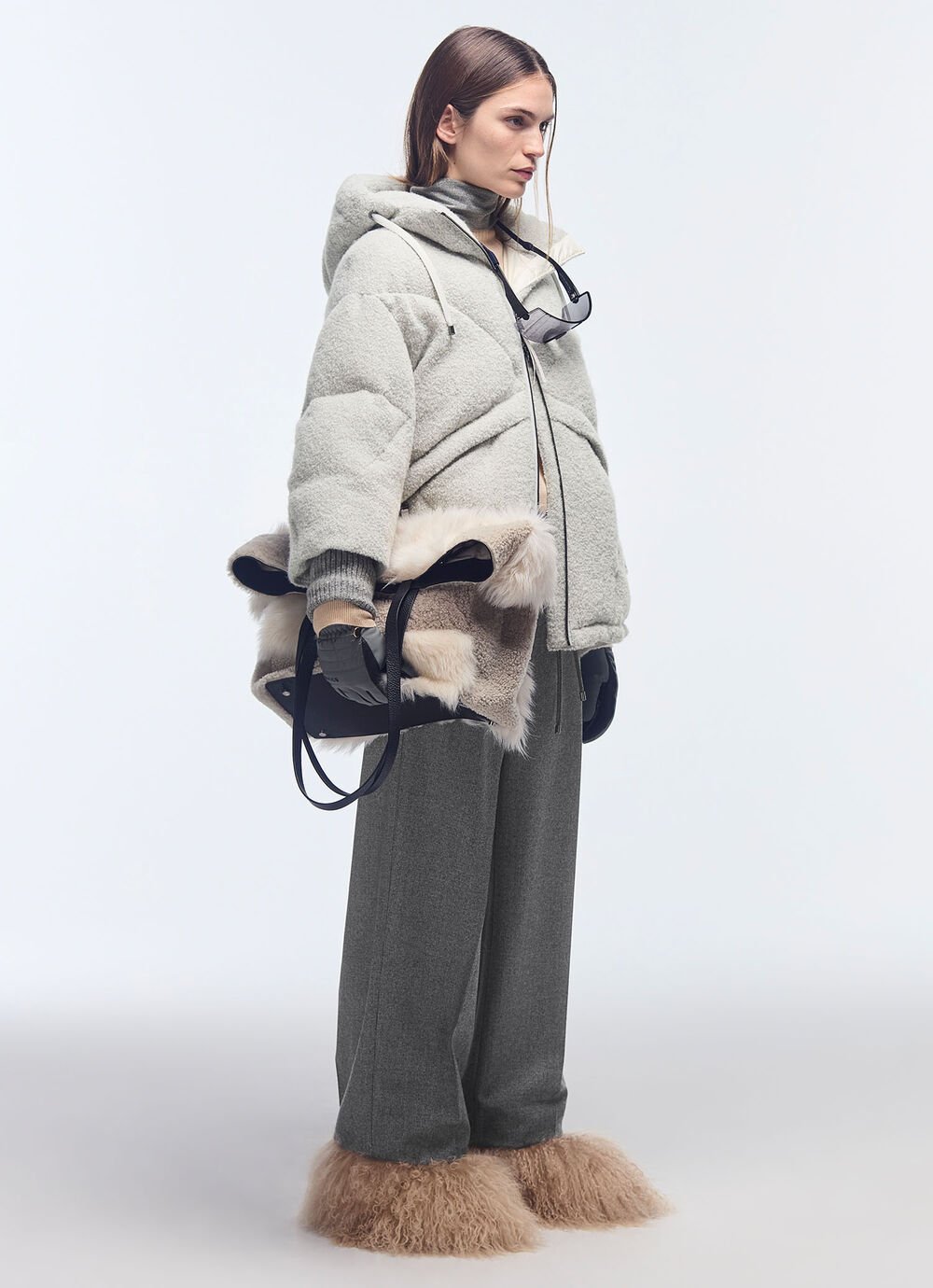 A grey, hooded down jacket, pleat-front trousers and boots create a feminine look that’s both warm and stylish. A grey, hooded down jacket, pleat-front trousers and boots create a feminine look that’s both warm and stylish.